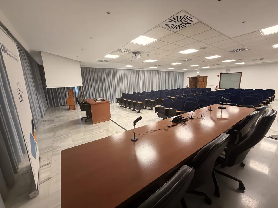 The panel table with microphones, facing the seats